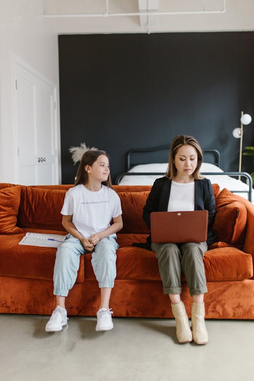 Free A Mother and Daughter Sitting on the Couch Stock Photo