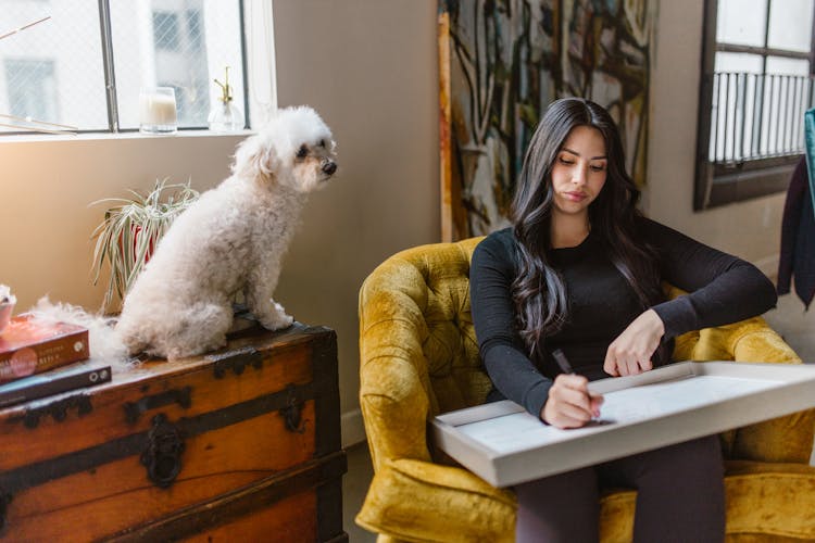 A Woman Drawing While Sitting