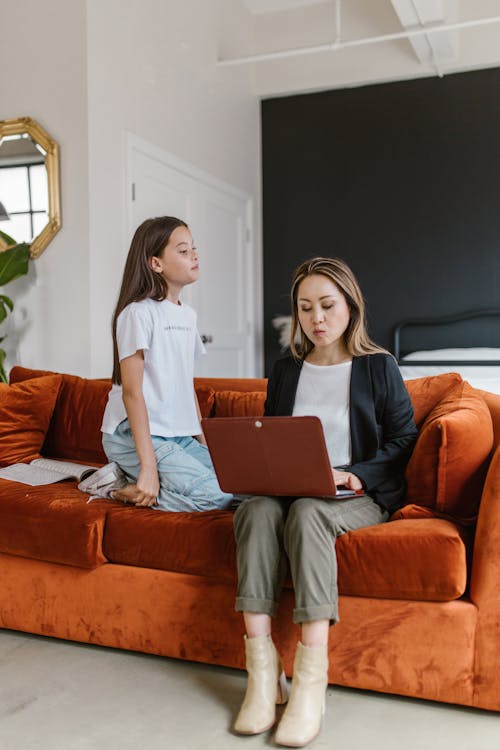 Free Mother and Daughter Sitting on the Couch Stock Photo