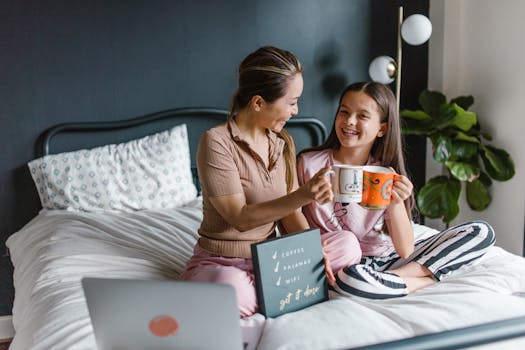 A joyful mother-daughter moment with coffee in a cozy bedroom setting, embracing family togetherness.