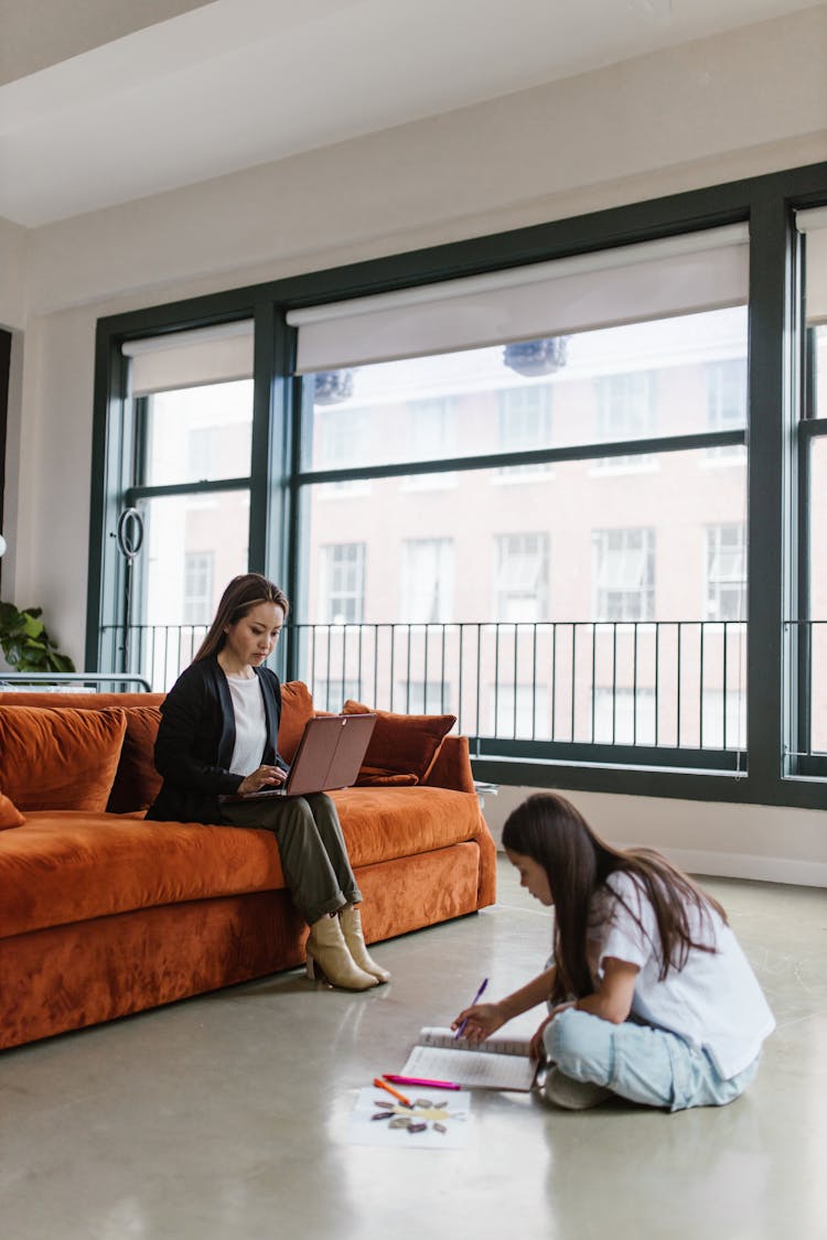 Women Working Inside An Apartment Living Room