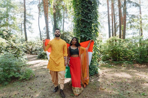 Man and Woman Wearing Traditional Clothes in the Forest