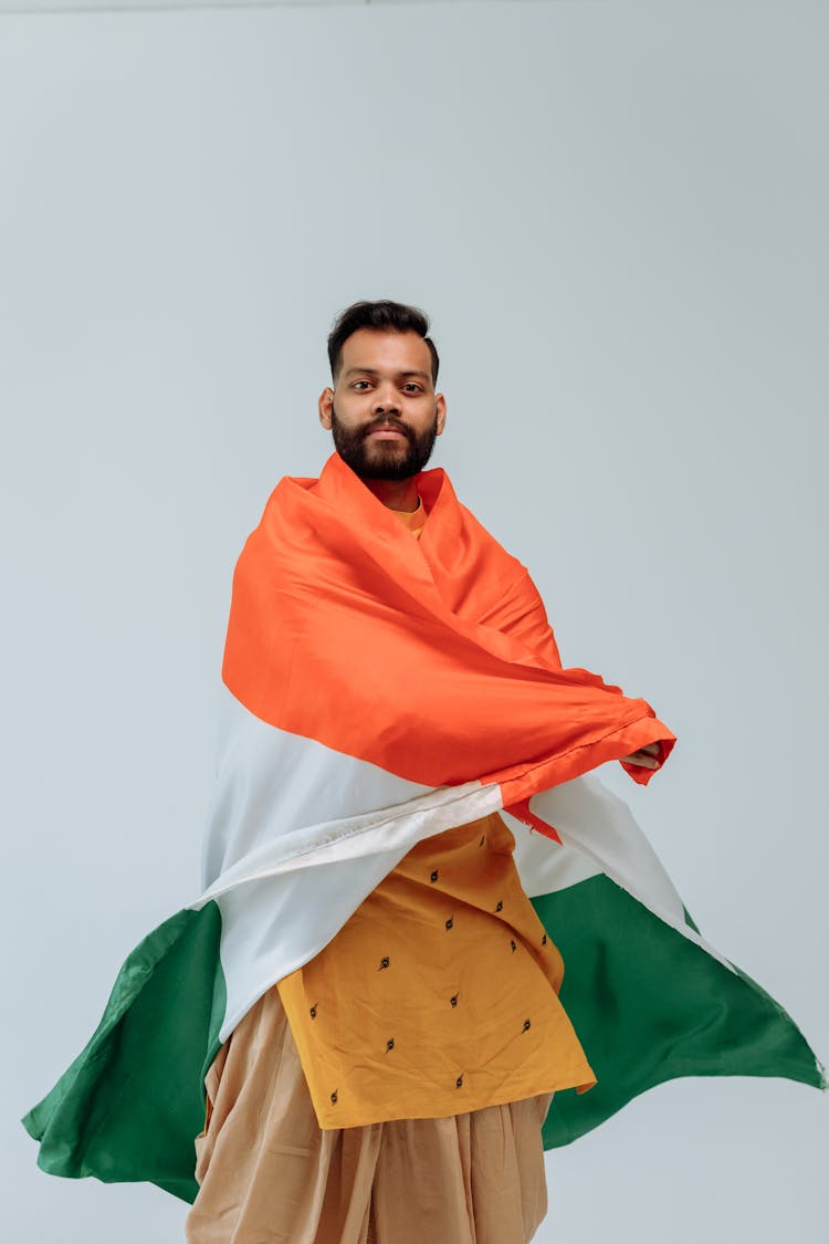 Studio Shoot Of A Man Wrapped In An India National Flag