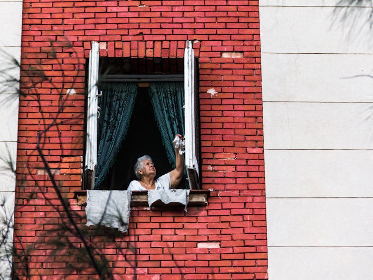 Woman Opening A Window