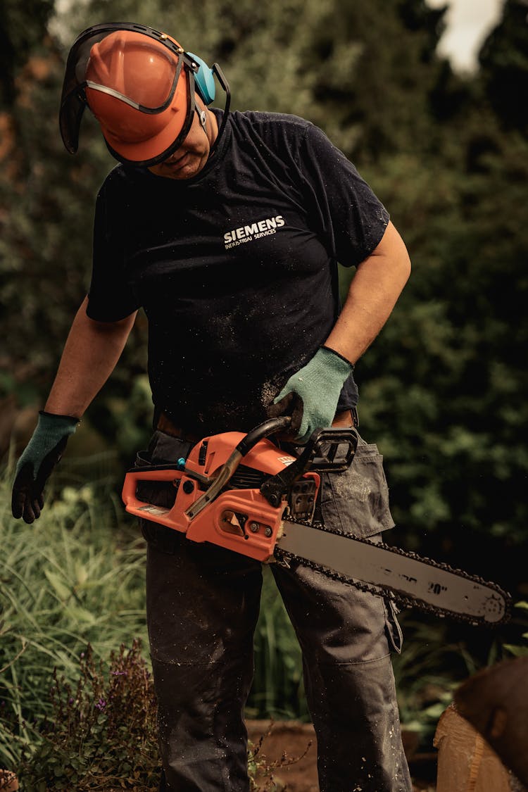 Man Holding A Chainsaw