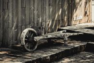An Old Wooden Wheel Cart in a Barn