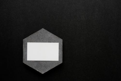 Close-Up Shot of a Business Card on a Black Surface