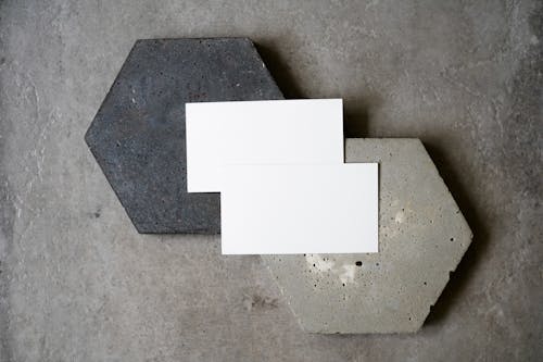 Blank Business Cards on Top of Black and Gray Stones