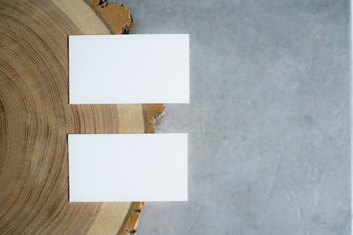 Free White Papers on the Edge of a  Wooden Table Stock Photo