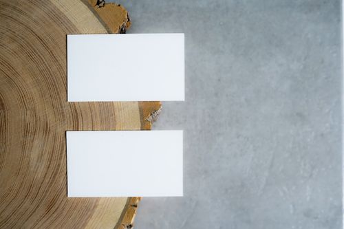 Blank business cards on wood and concrete, by PNW Production on Pexels