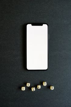 A blank smartphone screen with wooden letter dice spelling 'CREATE' on a black background.