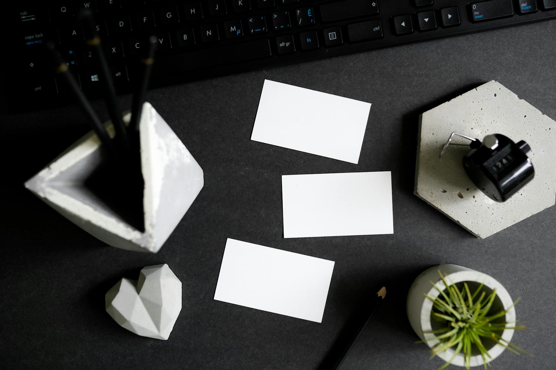 Stationery Keyboard and Business Cards Lying on Desk