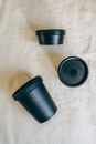 Black Plastic Containers on White Fabric