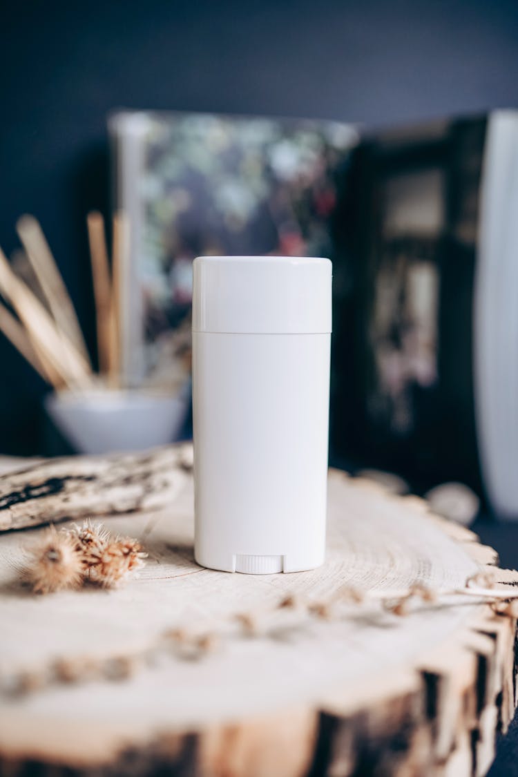 White Plastic Container On A Tree Stump Table