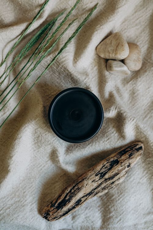 Free A serene still life featuring natural elements on a textured blanket. Stock Photo