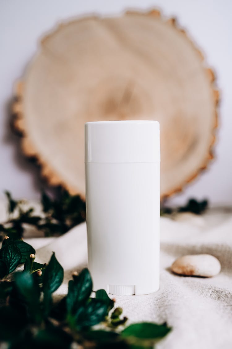 Scent Diffuser Standing On Table With Branches Of Leaves