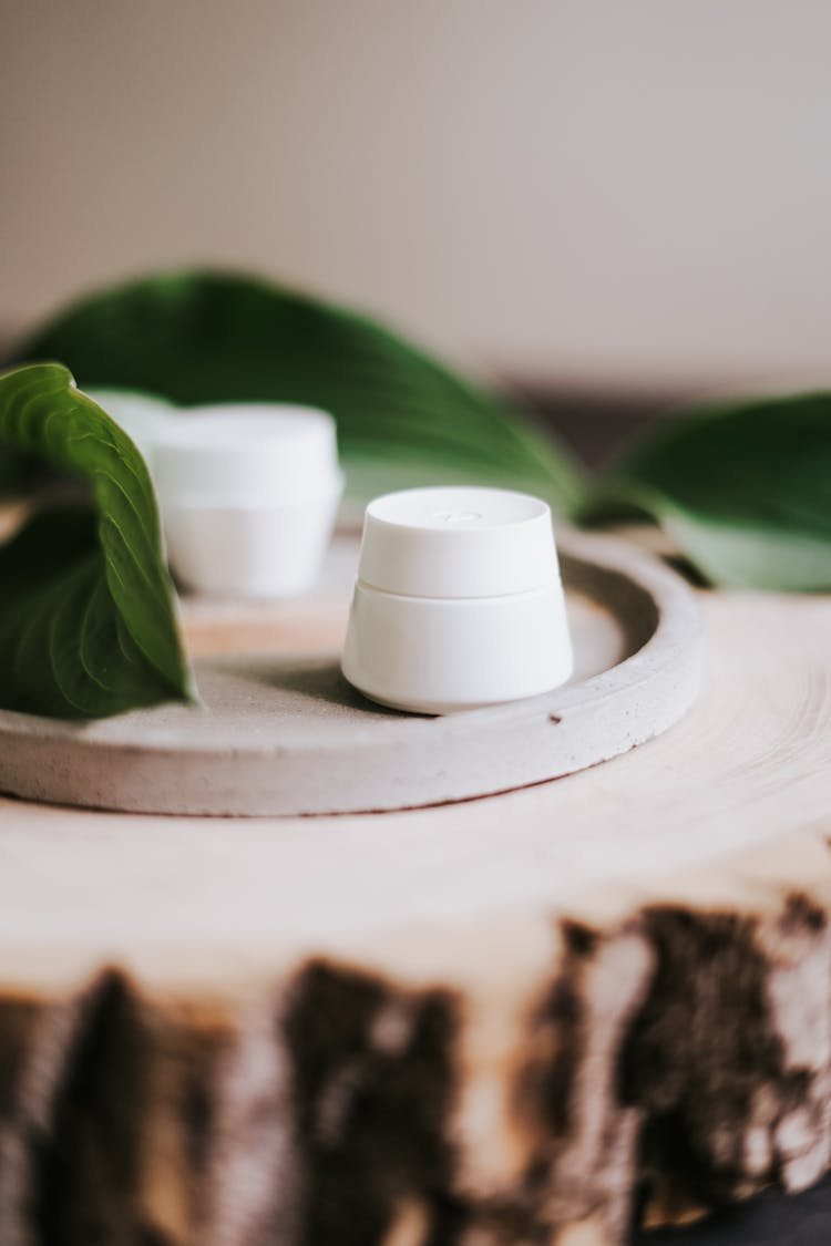 Undefined White Containers Placed On Wooden Tray