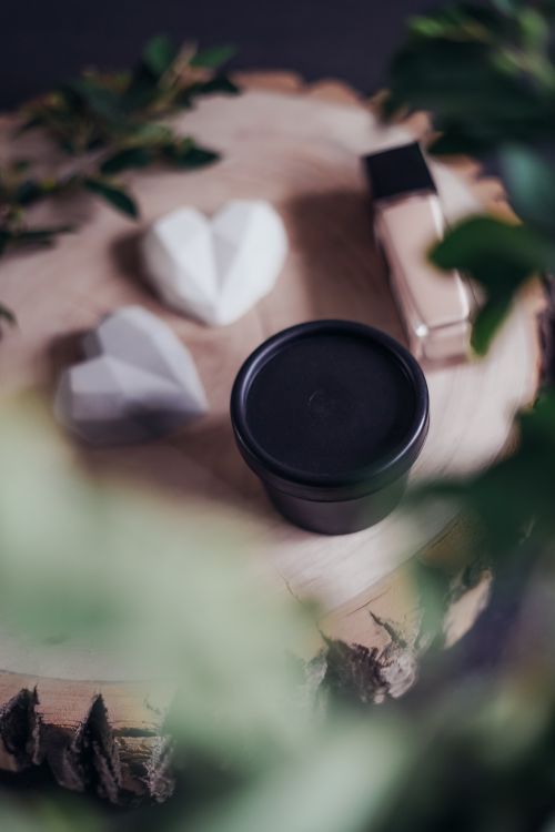 Free A stylish still life of beauty products on a wooden surface, surrounded by greenery. Stock Photo