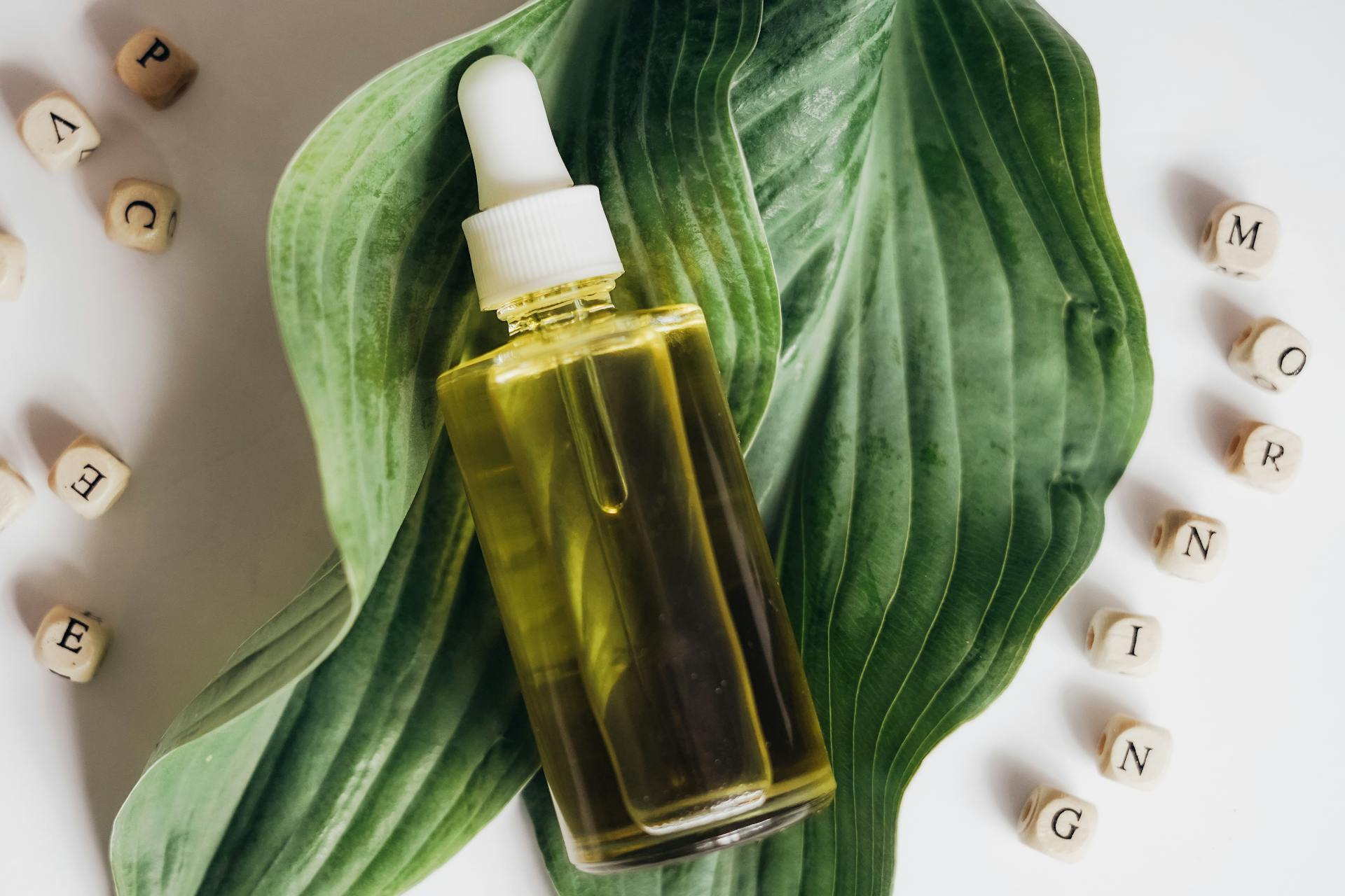 Oil in a Bottle with a Pipette on a Leaf