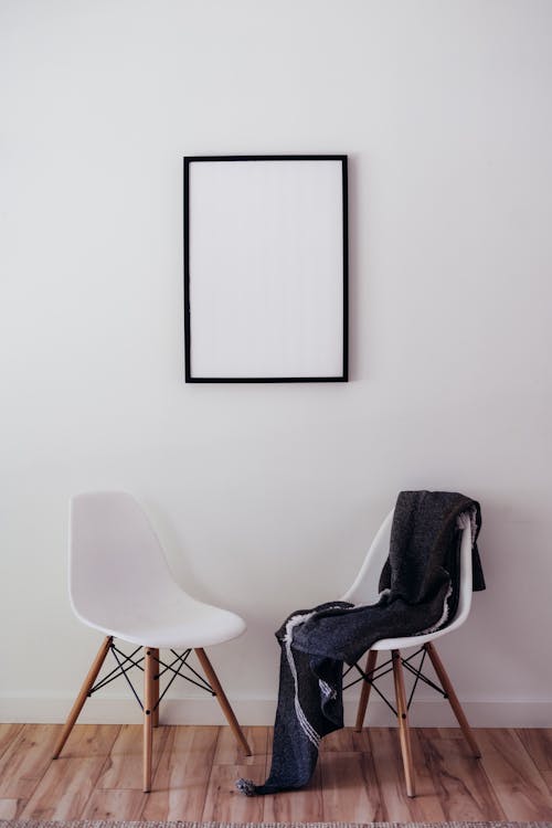 View of a Blank Frame and Two Chairs