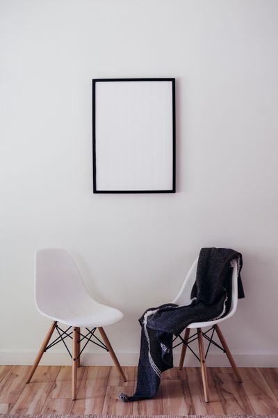 Two chairs against a bare white wall — photo by PNW Production on Pexels