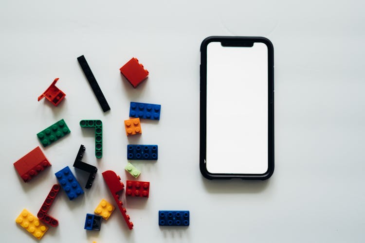 Toy Building Blocks Lying Next To Phone