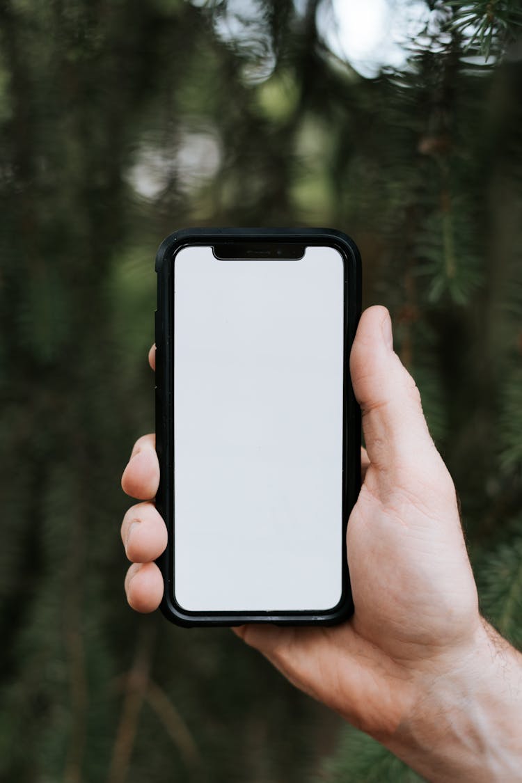 Person Holding An Iphone With Black Case