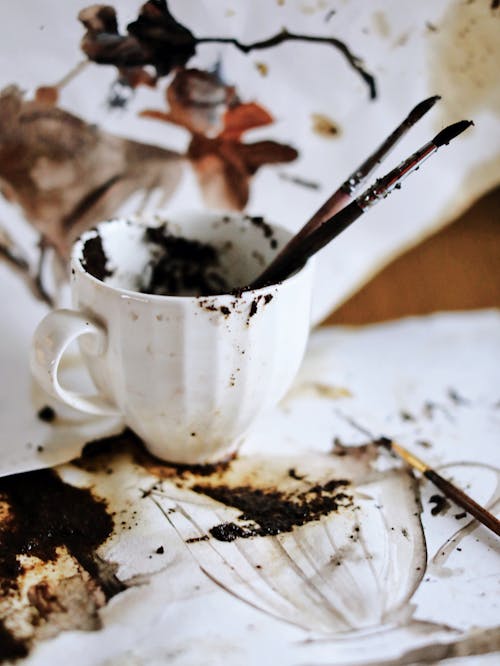 Dirty White Ceramic Cup With Paint Brushes
