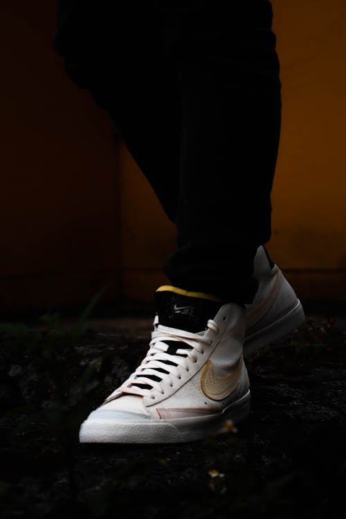 Free Person in Black Pants Wearing White Nike Sneakers  Stock Photo