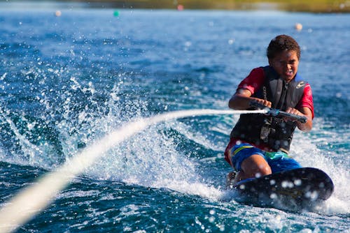 Man Wearing a Life Vest Wakeboarding 