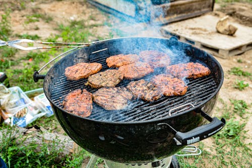 Free Grilled Meat on Black Charcoal Grill Stock Photo