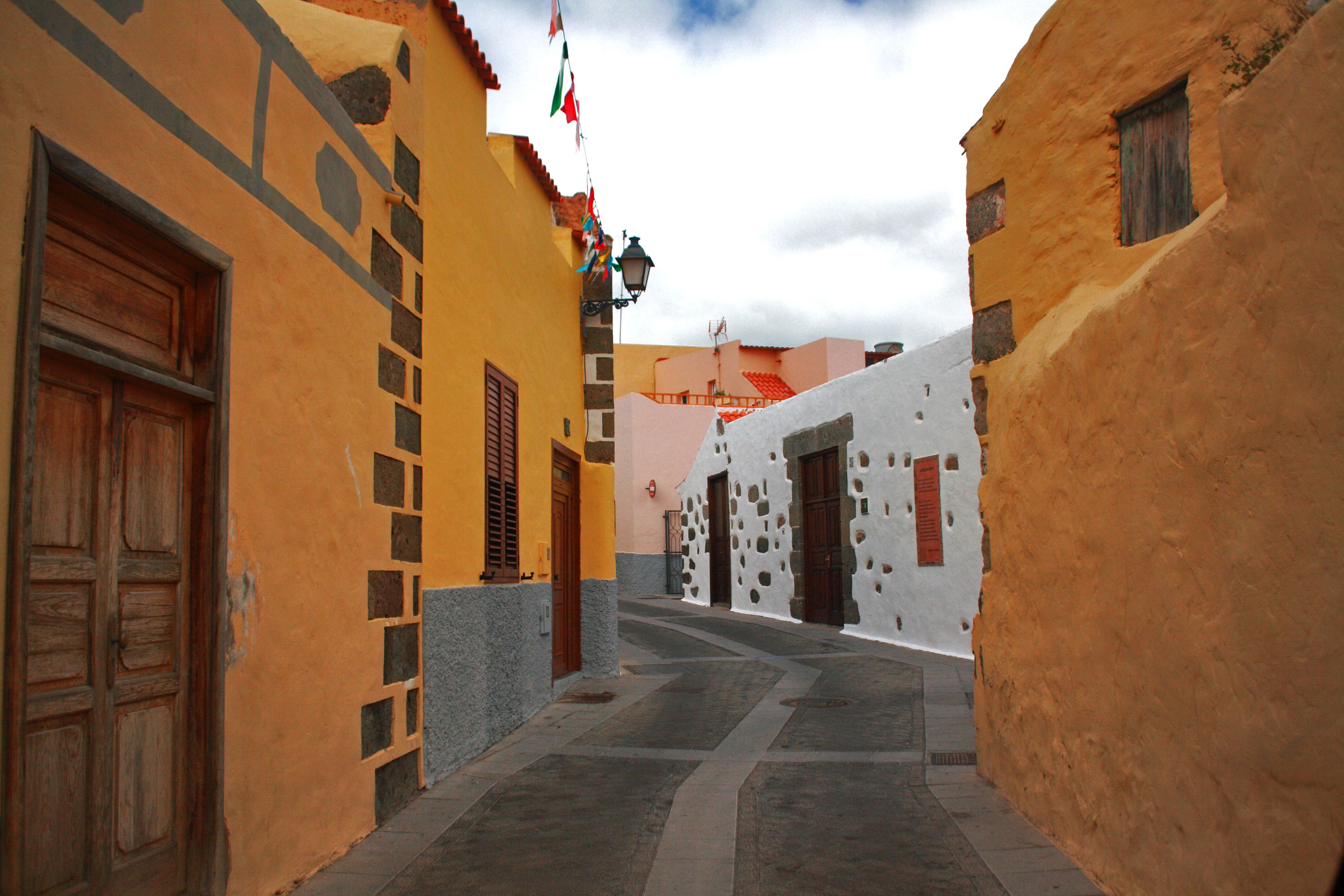 Adobe houses with tile roofs on a steep lane in a highland Lenca village in La Paz department