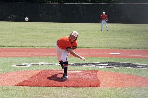 Free Young baseball pitcher throwing a pitch during a game on an outdoor field. Stock Photo