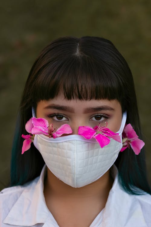 Free Woman in White Top Wearing White Face Mask with Pink Flowers on her Face Stock Photo