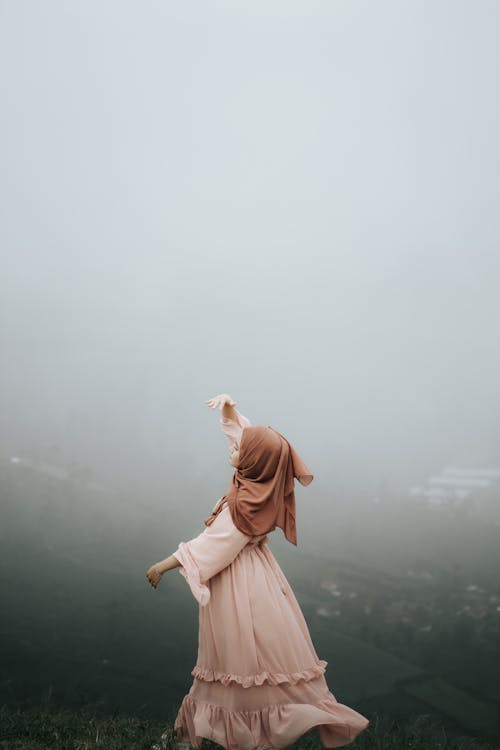 Woman in Pink Dress Standing on Foggy Environment