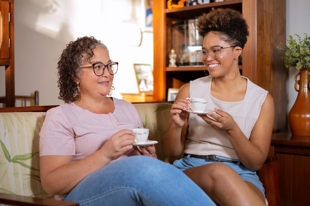 Two friends sharing tea at home