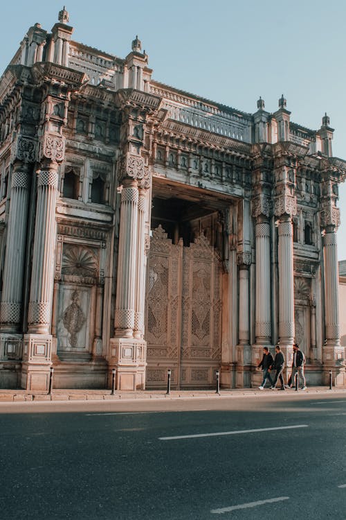 People Walking in Front of a Historical Building