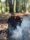 Burning Metal Firebox Stove on the Ground