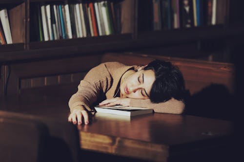 Free Woman Sleeping on a Table Stock Photo