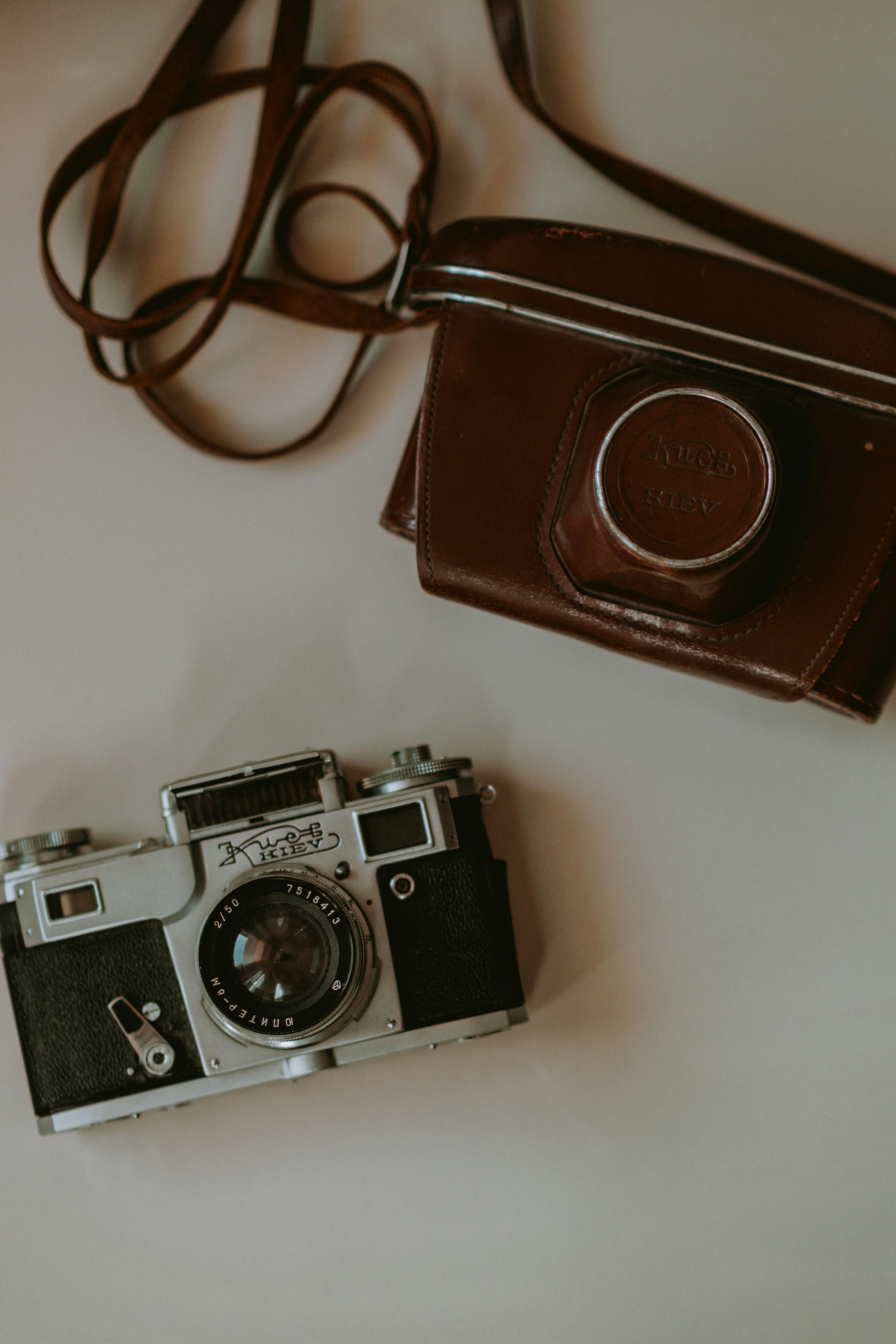 Classic analog camera with leather case, showcasing retro style and timeless design.