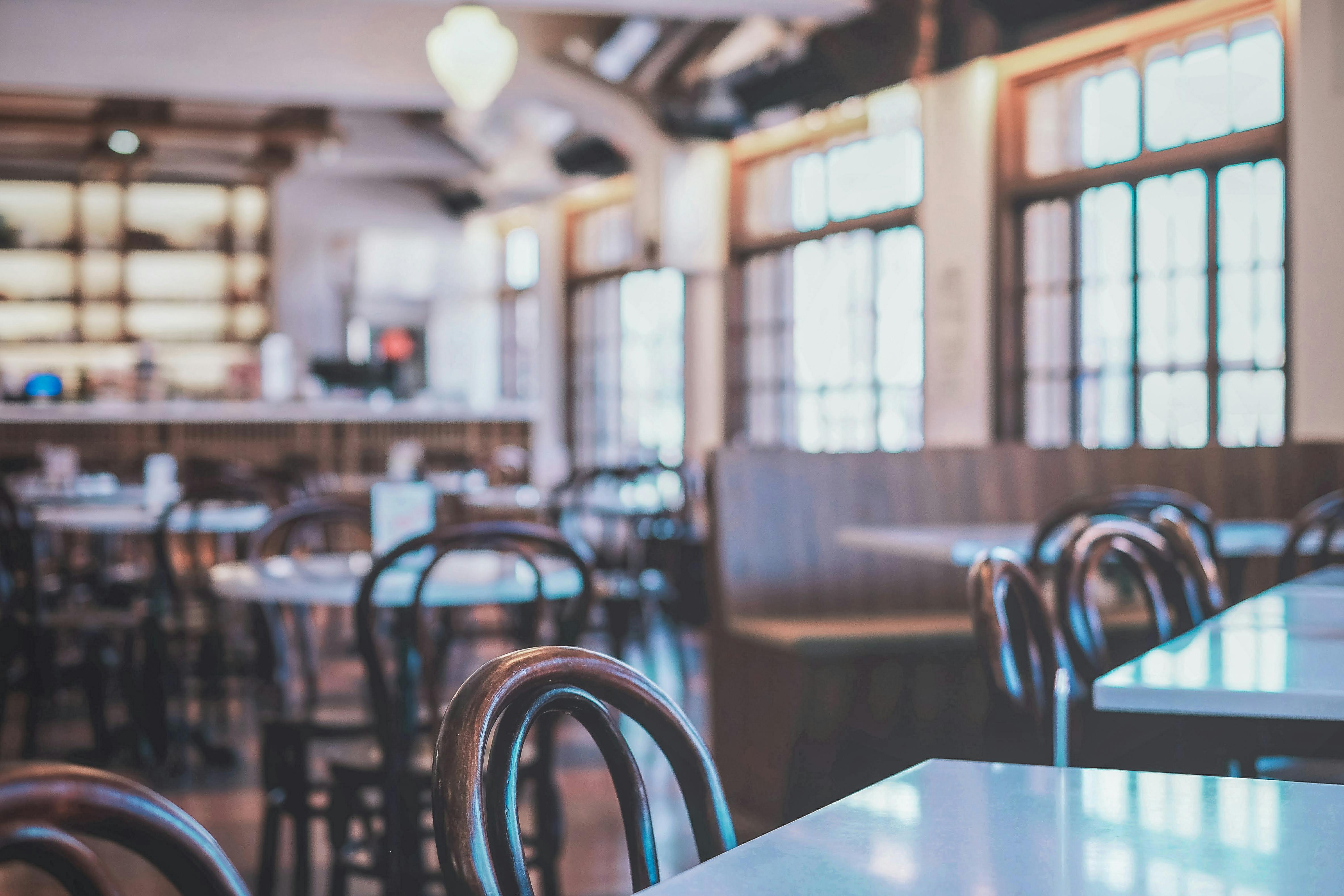 A stylish French bistro interior with neat seating, warm lighting, and classic architectural details. - best happy hour loop