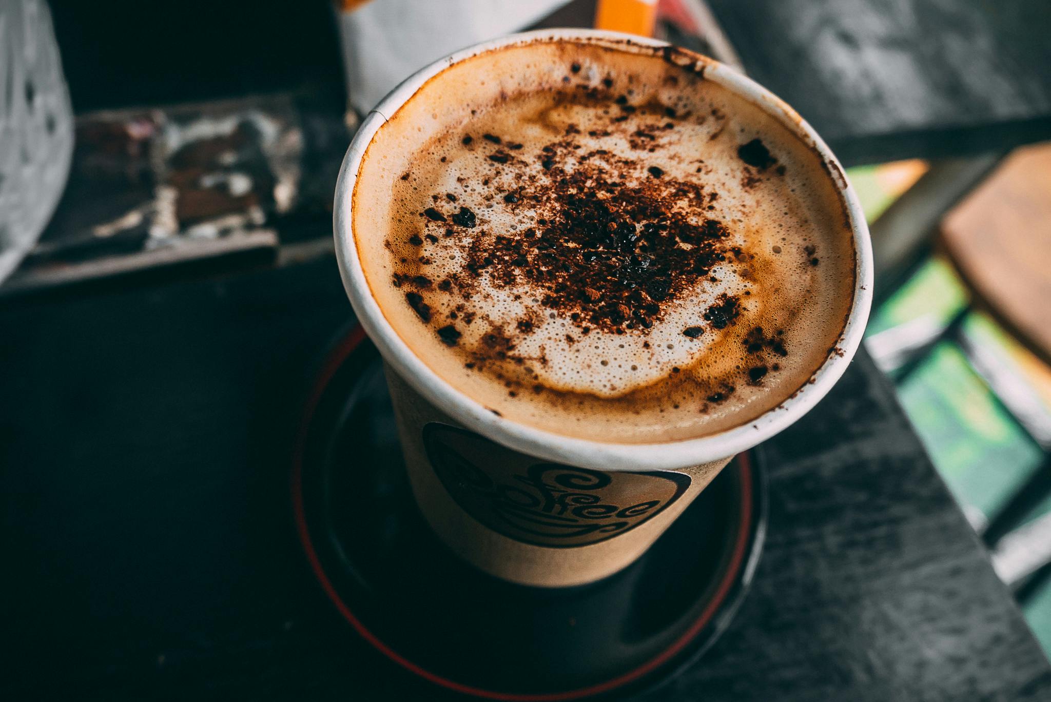 brown cup filled with cappuccino