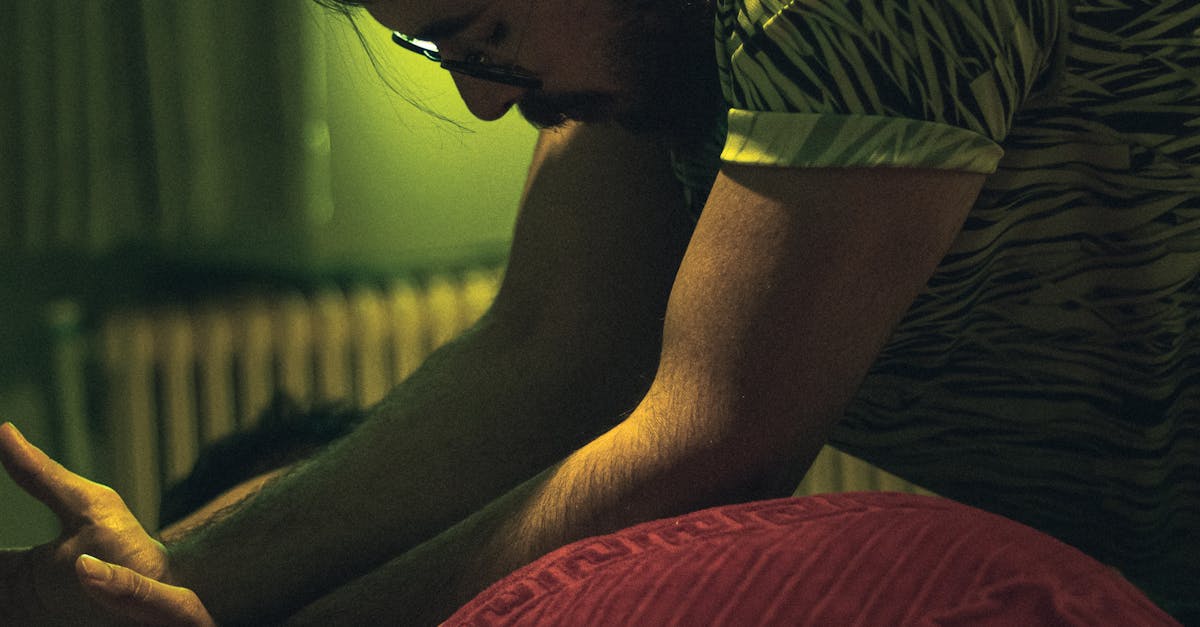 A person's hands demonstrating massage techniques on the neck area.