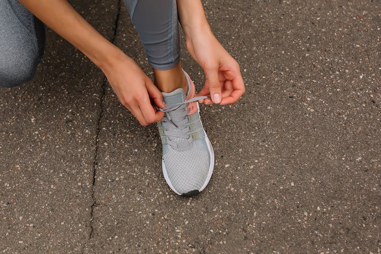 Person Tying Up Her Shoelace