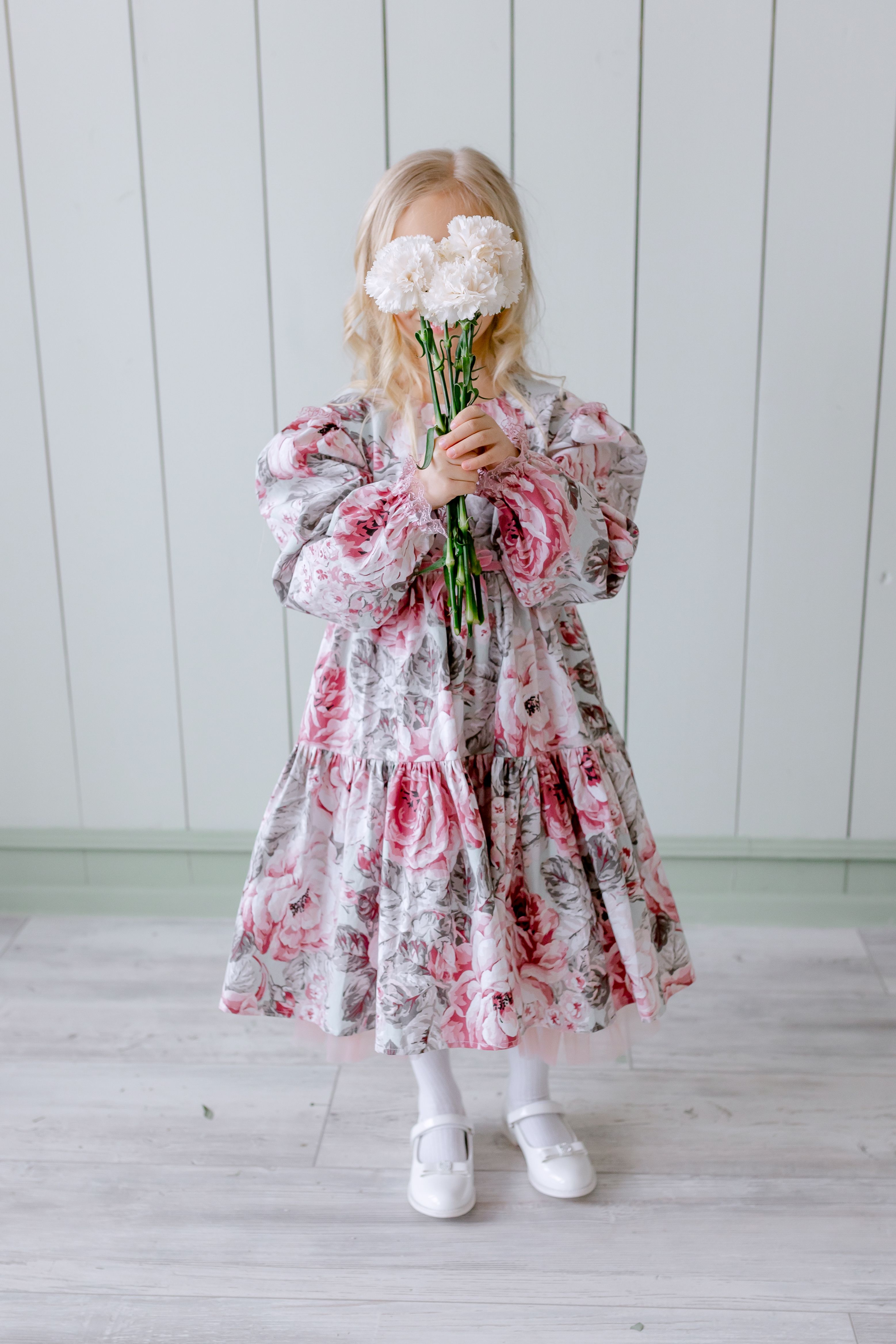 A Girl in Floral Dress Holding Flowers · Free Stock Photo