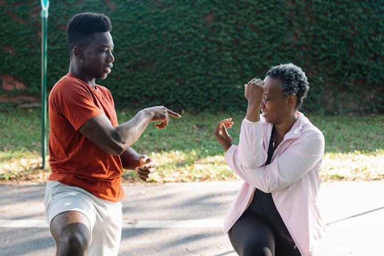 A Woman And Man Doing Workout Together