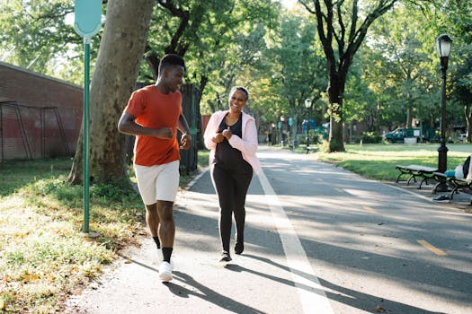 Happy African American couple jogging together in a sunny urban park.