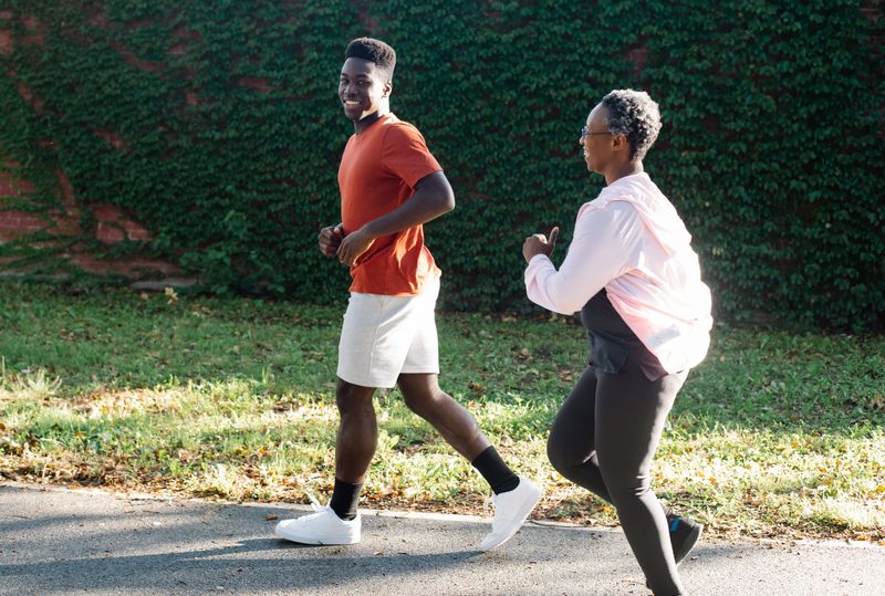 Two adults jogging together outdoors.