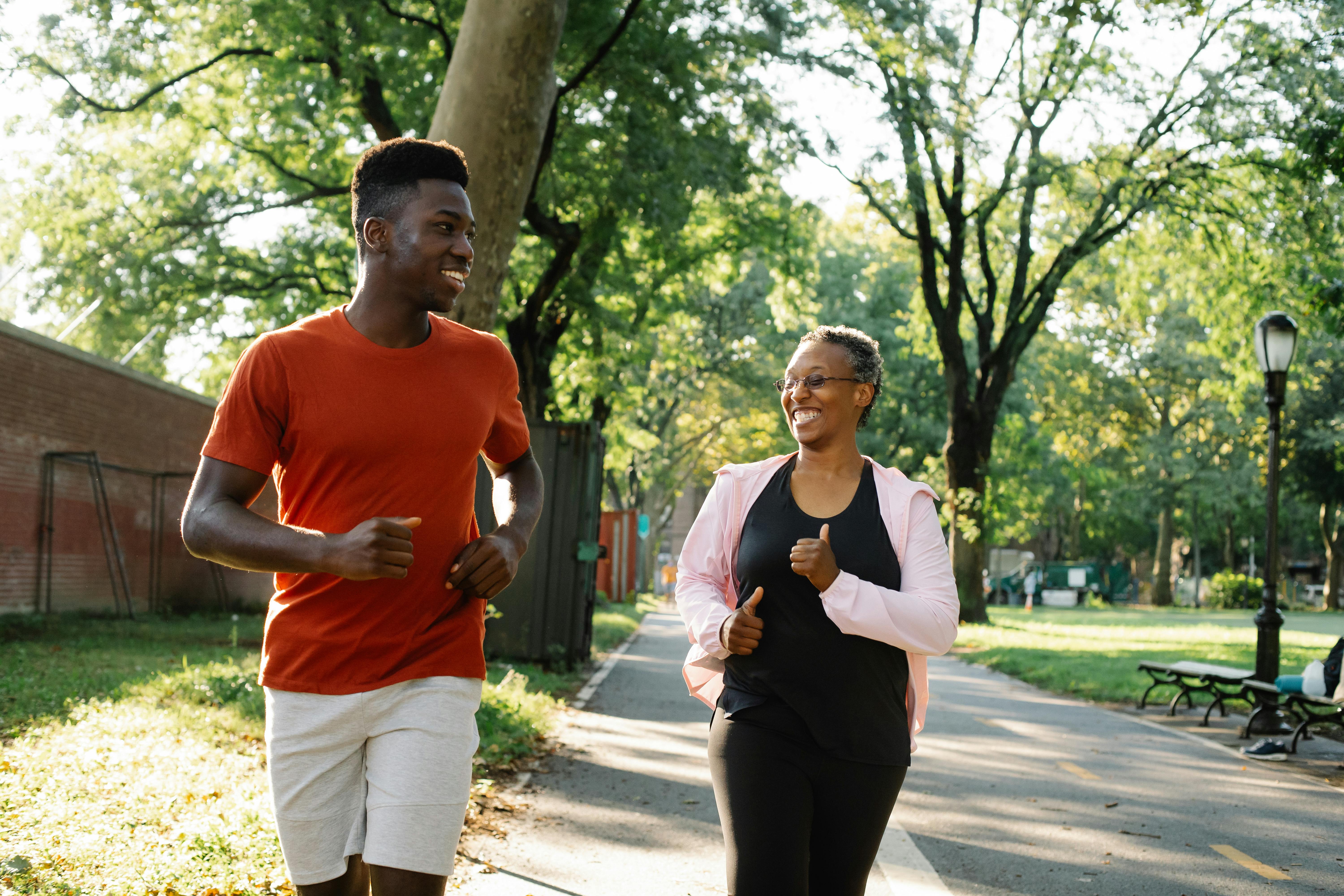 young man and elderly woman jogging