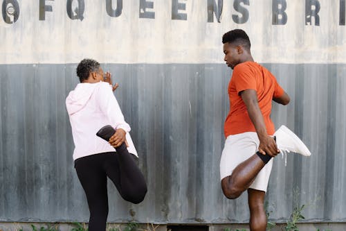 Two People Exercising Their Foot and Legs